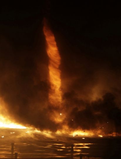SCIENCE AND NATURE Hungary. u201dTornados made out of fireu2026that is bad news, no matter how you photographic it. This fire tornado rises from a blaze at a plastics processing factory in the city of Kistarcsa on March 1.u201d Photo by Viktor Veres/Reuters, Washington Post