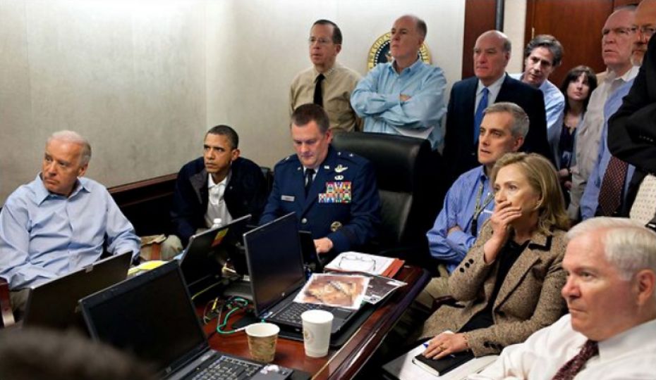 Bin Laden, Part 1. ”The photographic narrative of the events of May 1, 2011 begins in the basement of the White House, where President Obama and his senior staff gathered in the Situation Room to watch kept a real-time vigil as Navy Seals dropped into Osama bin Laden’s compound in Abbottabad, Pakistan. The picture is from the official White House photographer. A classified document in front of Hillary Clinton has been blurred out.” Photo by Pete Souza/The White House, New York Times