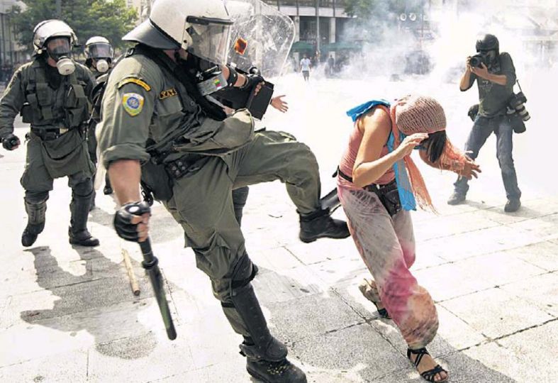 Athens on a June day, the police, the demonstrator, and the photographer...The Times, 16 June. Photo : Lefteris PItarakis / AP