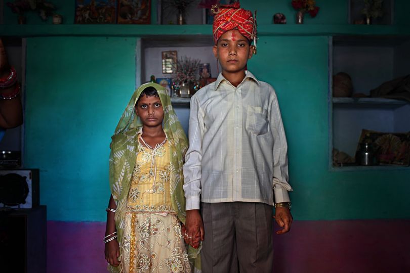 Maya, 8, and Kishore, 13, pose for a wedding photo inside their new home the day after the Hindu holy day of Akshaya Tritiya, or Akha Teej, in Rajasthan, India on April 29, 2009. © Stephanie Sinclair / VIIrn