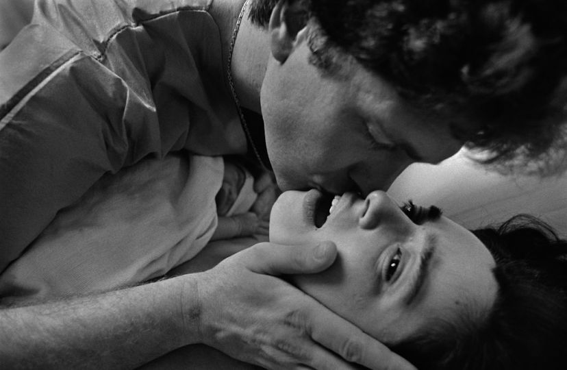 WASHINGTON, DC - DECEMBER 1990: After the birth of his first child, new father Jim Vogt kisses his wife, Sarina, at Georgetown University Hospital in December 1990 in Washington, D.C. Jim hadn't noticed that the baby was a boy, whom the couple named Zachary. © Eugene Richards