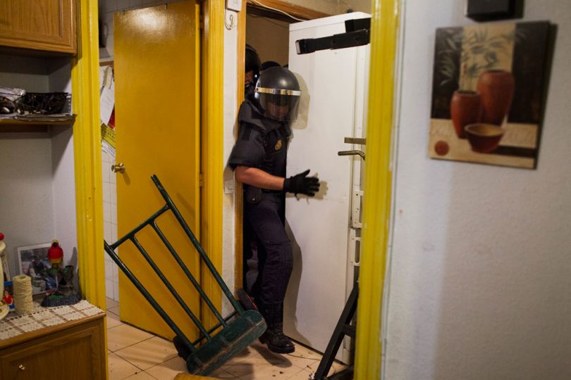 Police remove the door and push refrigerator as they break into Maria Isabel Rodriguez Romero's apartment to evict her and her family in Madrid, Spain, Wednesday, Sept. 25, 2013. Rodriguez Romero, 45 years old, has 6 family members, all unemployed including a 8 year-old daughter, and her mother with a bipolar syndrome. They live together in an apartment of the State City Hall Housing Company (EMVS) for 24 years and they have paid a debt of 1200 euros but EMVS informed them they have to move out. EMVS, a state company with an aim to give housing solutions for people in need, sold 1.860 state apartments to private investors in 2013. The eviction was executed despite of the resistance of dozens of Victims' Mortgage Platform (PAH) activists. (AP Photo/Andres Kudacki)n