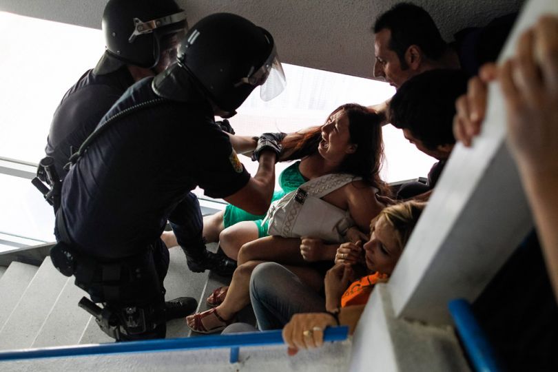 Police remove members of the Victims' Mortgage Platform (PAH) and neighbours as they try to stop the eviction of Susana Santiago Montoya and her family in Madrid, Spain, Wednesday, July 24, 2013. Santiago Montoya and her husband Angel Gimenez Santiago, who are both unemployed, have two children aged 7 and 10 and have occupied an apartment of the City Hall Housing Company (EMVS) for the past year, as they could not afford to pay rent. (AP Photo/Andres Kudacki)n