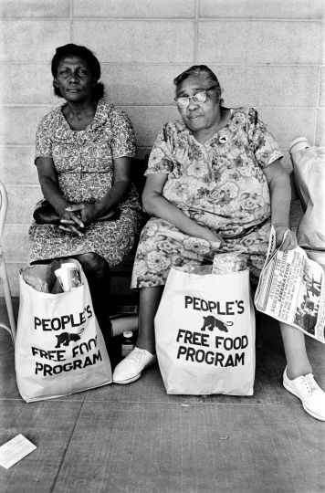 Two women with bags of food at the People's Free Food Program, one of the Panther's survival programs. 1972