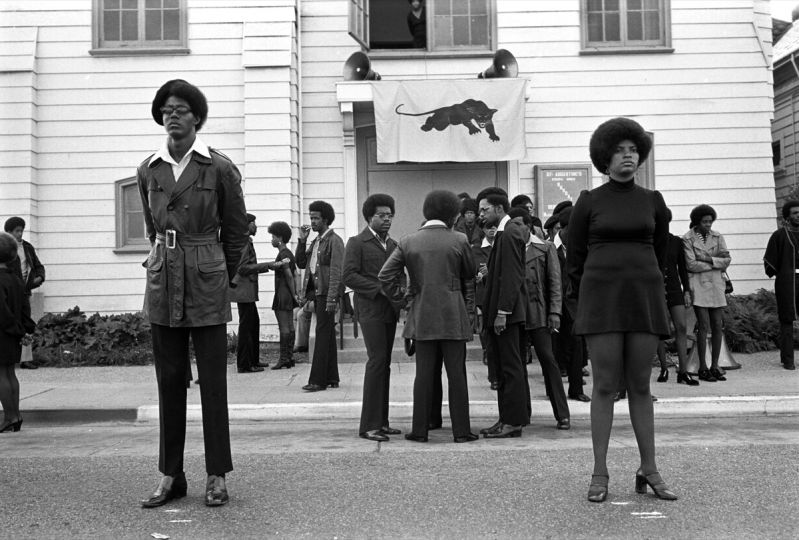 August 28, 1971 - Oakland, California, USA: George Jackson funeral at St. Augustine’s Church. Glen Wheeler and Claudia Grayson, known as Sister Sheeba, stand in front. Clark Bailey, known as Santa Rita has cigarette in his mouth. 2nd row: Van Hilliard, known as Van Junior, John Seale (Bobby’s brother back to us), Van Taylor. (Stephen Shames/courtesy Stephen Kasher Gallery)
