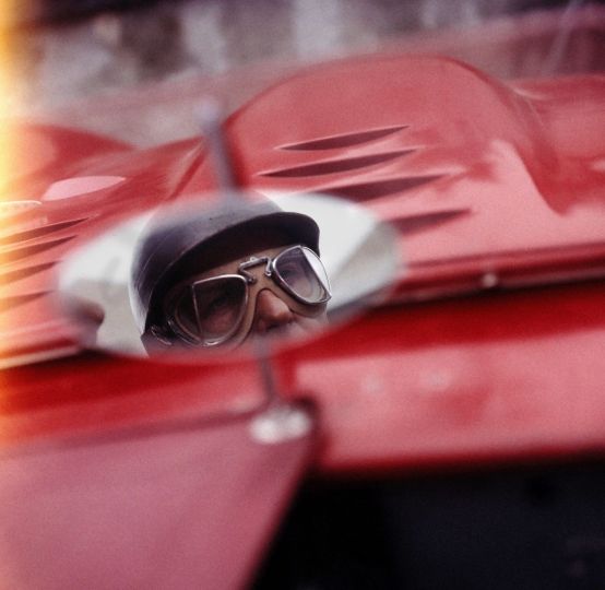 Close up of Argentinian race car driver, Juan Manuel Fangio, in rearview mirror - 1957 - Howard Sochurek ©The LIFE Picture Collection