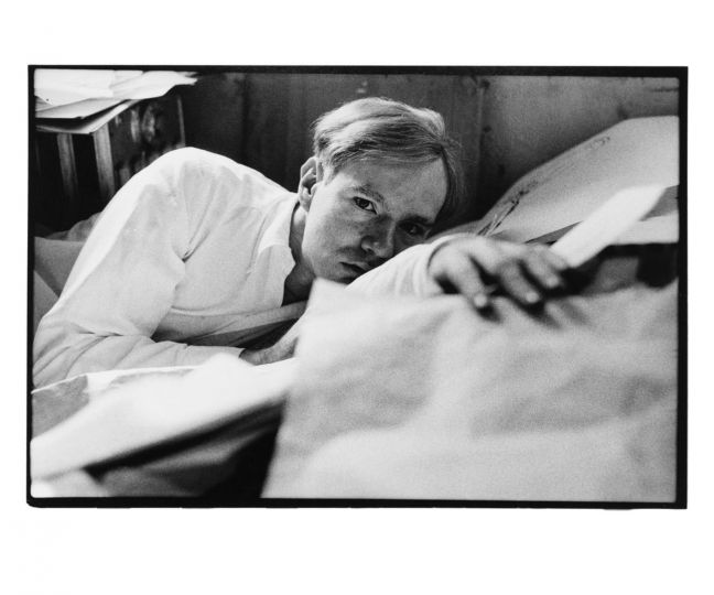 Andy Warhol (Laying on Papers), c. 1958 © Duane Michals. Courtesy of DC Moore Gallery, New York.