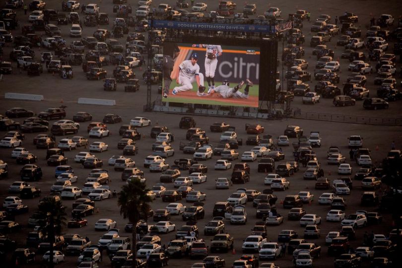 Fans watch in their cars during a drive-in live broadcast of game 2 of the World Series between the Tampa Bay Rays and the Los Angeles Dodgers in the parking lot of Dodger Stadium in Los Angeles on Wednesday, Oct. 21, 2020. (Ringo Chiu via AP)