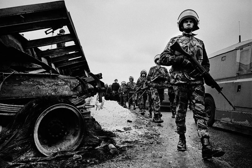 British Army patrol on the Nationalist Falls Rd after a night of rioting. Belfast 1987. Northern Ireland © Mark Abrahams - Courtesy of Bluecoat Press