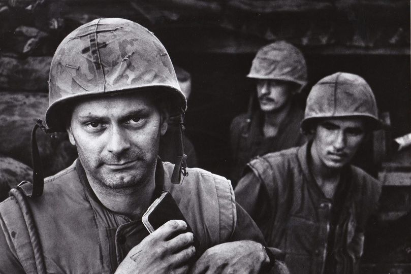 David Douglas Duncan - Chaplain Richard Black, never before under fire, ignored another salvo to come pray for a Marine who fell at the bunker entrance where Mike Company always shaved. Con Thien, September 1967
Vintage ferrotyped gelatin silver print by David Douglas Duncan - Courtesy Collection Michael Mattis & Judy Hochberg