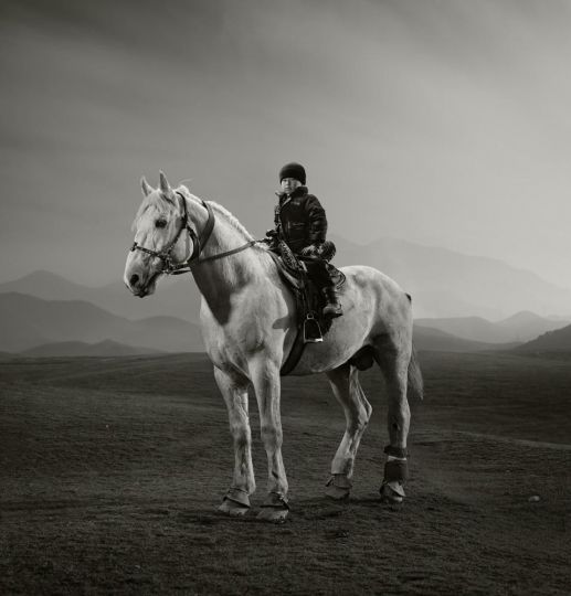 © Todd Antony- Buzkashi, meaning “goat pulling” in Persian, is the wild, brutal sport of Tajikistan and its neighboring ‘Stans.’ Think polo - but with a headless, eviscerated goat instead of a ball, hundreds of riders, and no formal teams. Rooted in the nomadic cultures of Central Asia and played for hundreds of years, riders battle for control of the goat while dodging rivals (and the occasional whip & elbow) This is 4 year old Abdulqadir, during a quiet hilltop moment with the Buzkashi match still thundering away in the narrow valley below us. We were setting up our flash equipment and taking portraits of some riders from his group of family and friends. Unprompted, he strolled into our makeshift hilltop studio on his biblically large horse. Made to look even larger by Abdul’s diminutive presence on top of him, feet tantalisingly close to actually reaching its stirrups. Yet with the confidence of a Tajik John Wayne, he turned his horse onto the mark I gestured at and posed without direction.